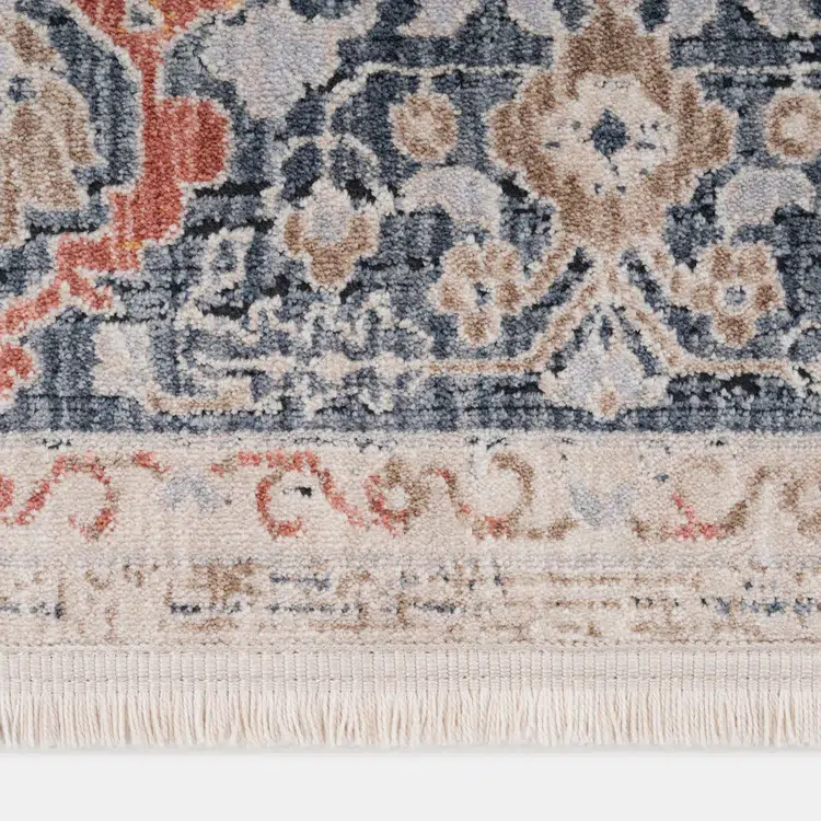 Close-up of the corner of Babylon Rose Rug, showcasing detailed floral motifs in navy, beige, and terracotta tones.