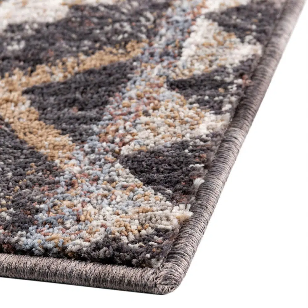 Close-up of the Boho Mirage Rug’s edge, showcasing its durable binding and intricate geometric patterns in earthy tones.