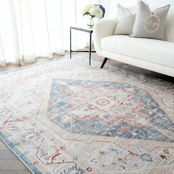 Classic Ishtar Medallion Rug in Dusty Aqua with intricate patterns, placed in a modern living room setting.