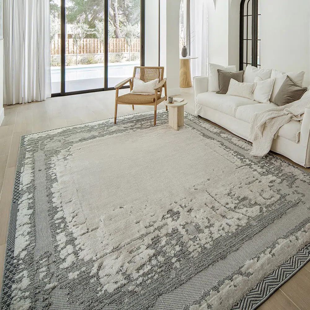 Modern living room styled with the Mist Haven Rug, featuring a distressed gray and cream design that complements the minimalist decor.