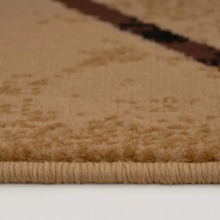 A detailed close-up view of the Alhambra Geometric Rug edges, showcasing its precise weave and soft texture in sandy beige tones.