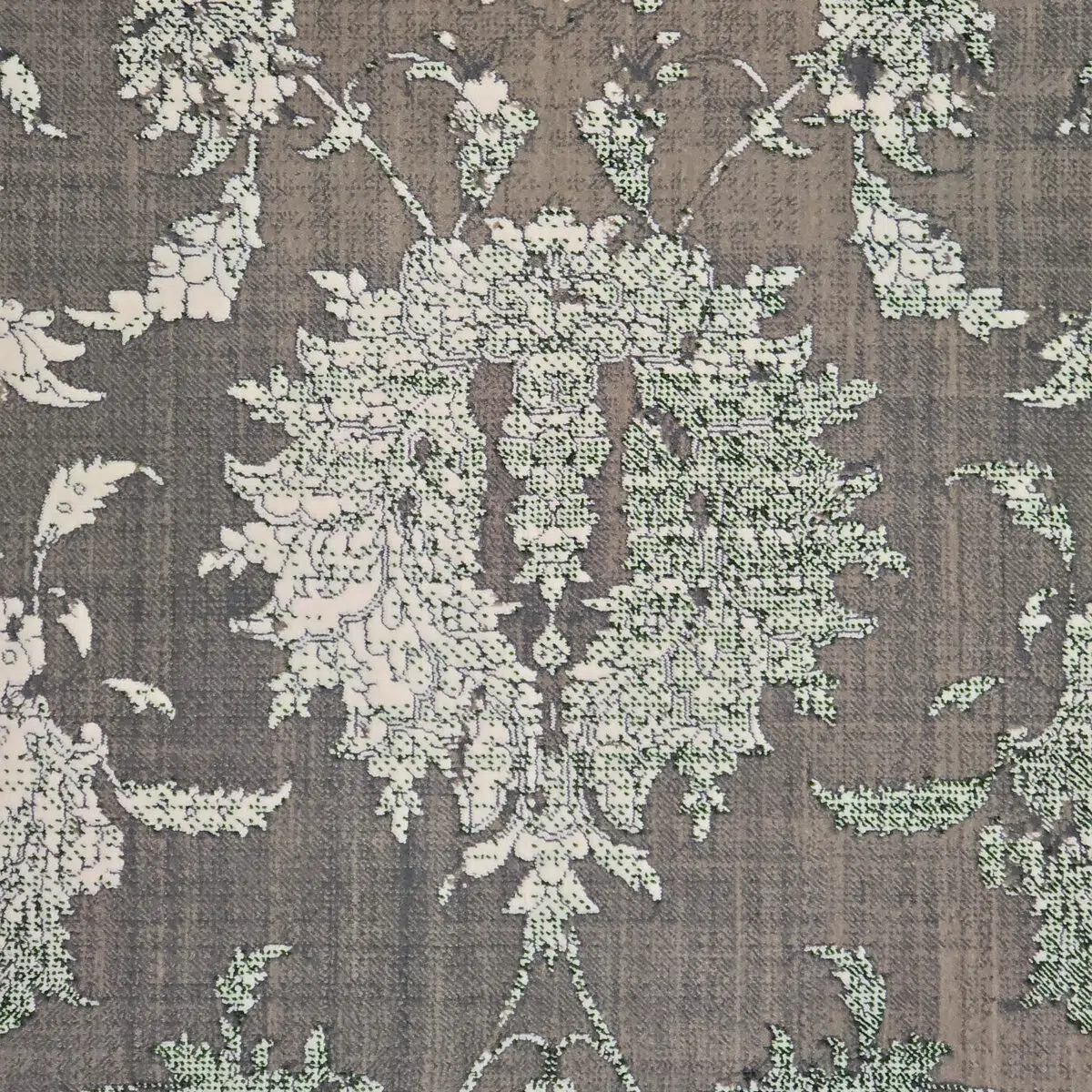 Close-up of the Emerald Carpet’s intricate floral motif, showcasing distressed vintage detailing in soft green, taupe, and ivory tones.